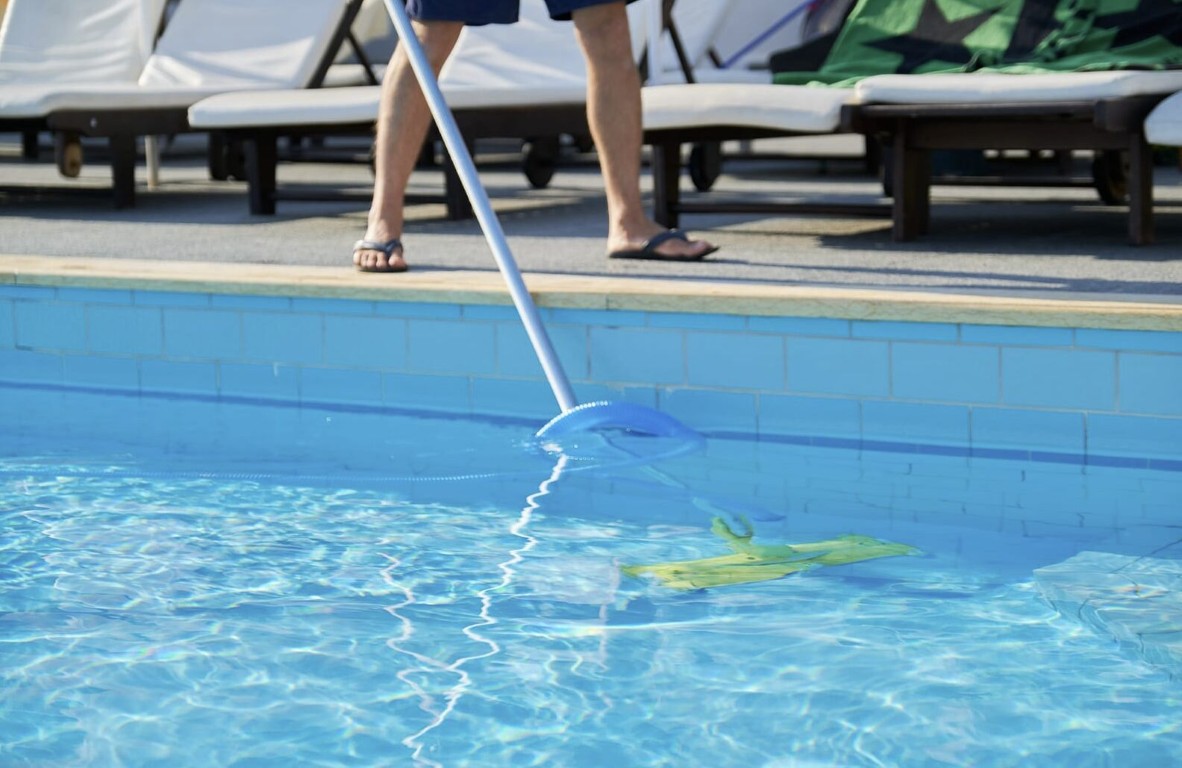 Professional pool technician performing weekly pool cleaning service in Montebello, CA