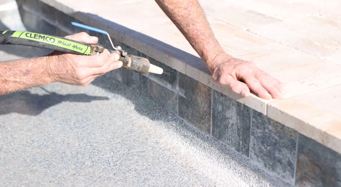 Pool tile cleaning and calcium scale removal in progress
